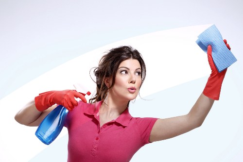 Cleaner wearing PPE while carrying out carpet cleaning work